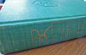 It's so old you can hardly see the title which is embossed in gold on the green fabric. 